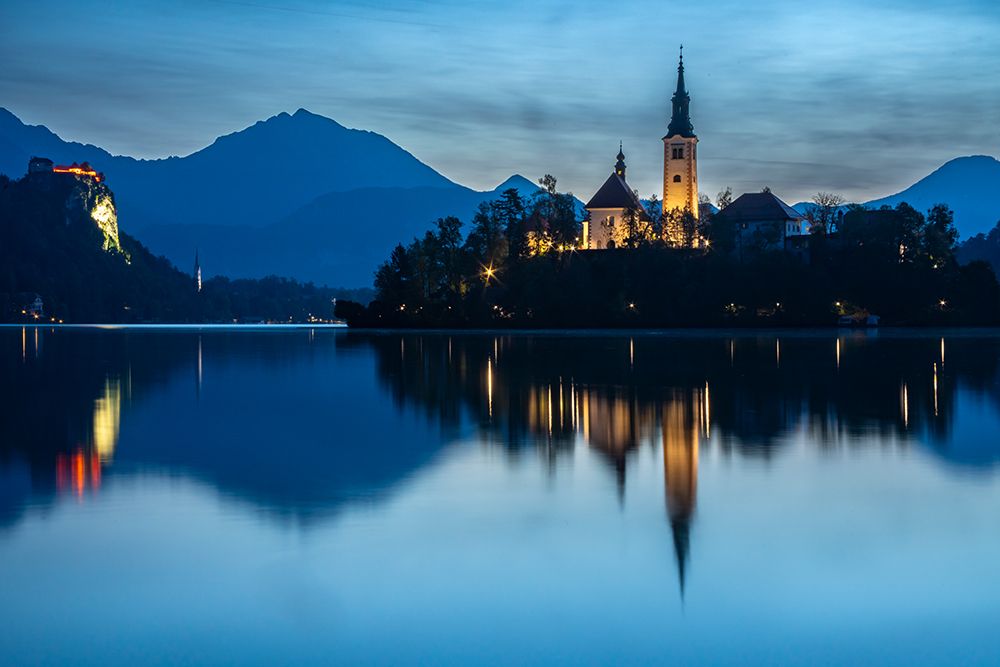 Slovenia, Lake Bled. Sunset lighting reflects in lake. art print by Jaynes Gallery for $57.95 CAD