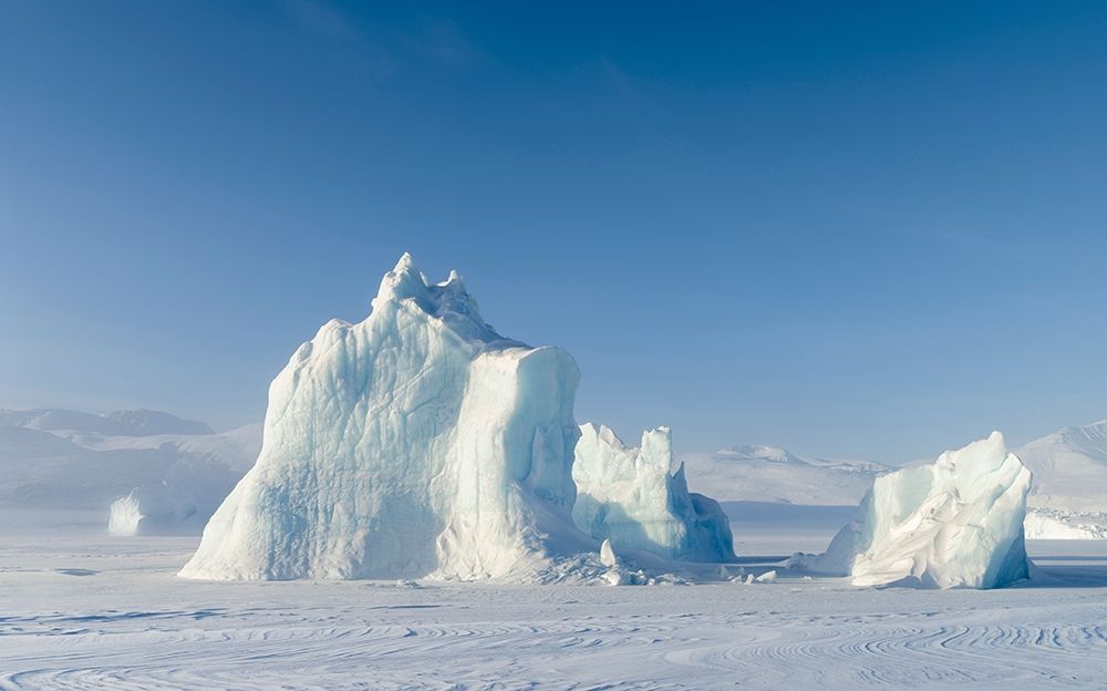 Icebergs frozen into the sea ice of the Uummannaq Fjord System during winter art print by Martin Zwick for $57.95 CAD
