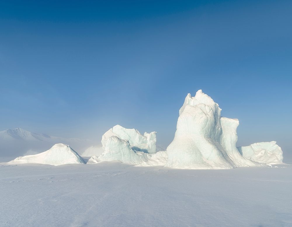 Icebergs frozen into the sea ice of the Uummannaq Fjord System during winter art print by Martin Zwick for $57.95 CAD