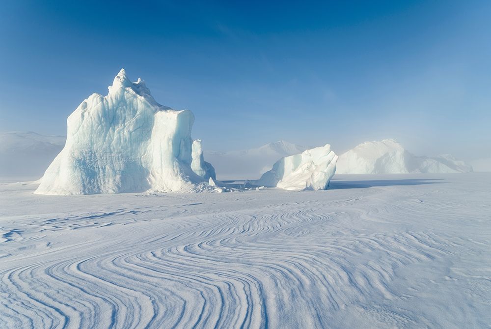 Icebergs frozen into the sea ice of the Uummannaq Fjord System during winter art print by Martin Zwick for $57.95 CAD