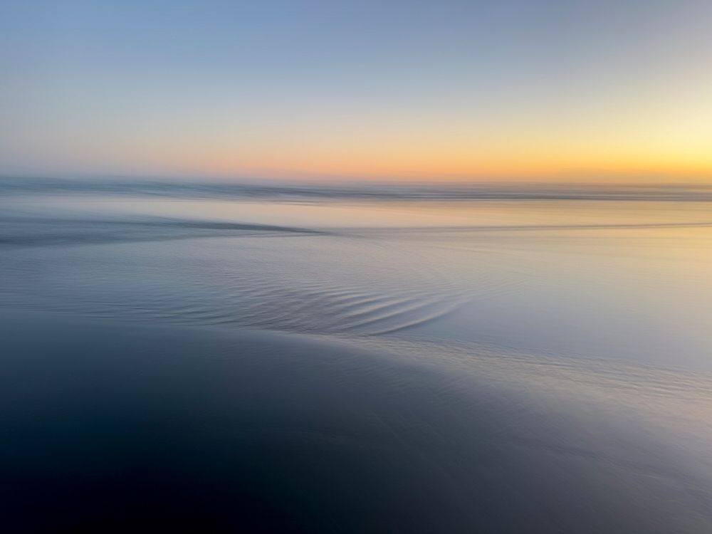 Abstract blur of sunset over water-covered beach. art print by Merrill Images for $57.95 CAD