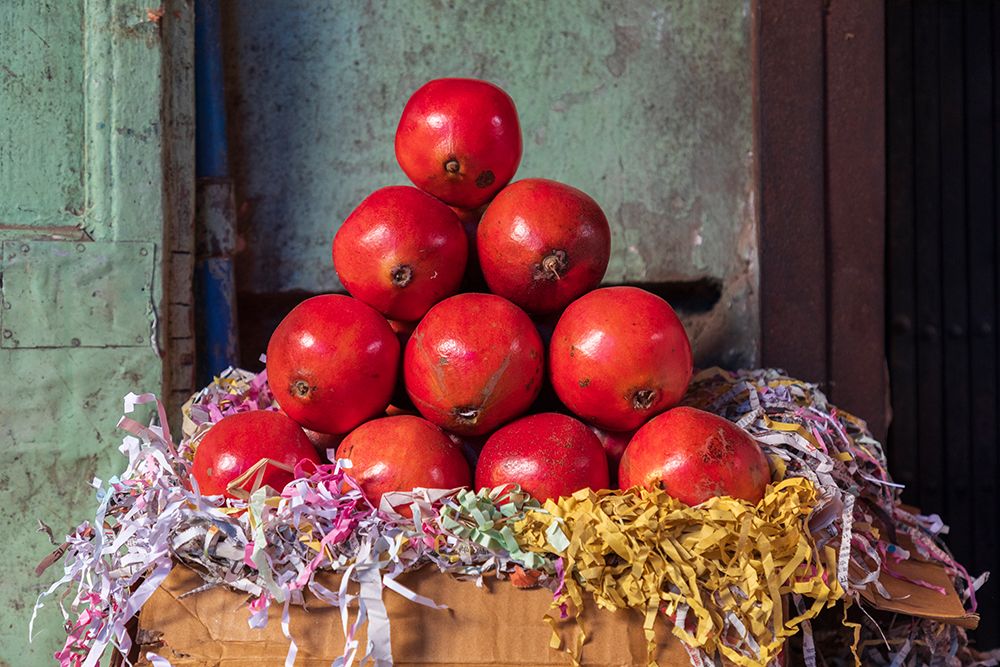 Still-life of a pyramid stack of pomegranates in a market. art print by Emily M. Wilson for $57.95 CAD