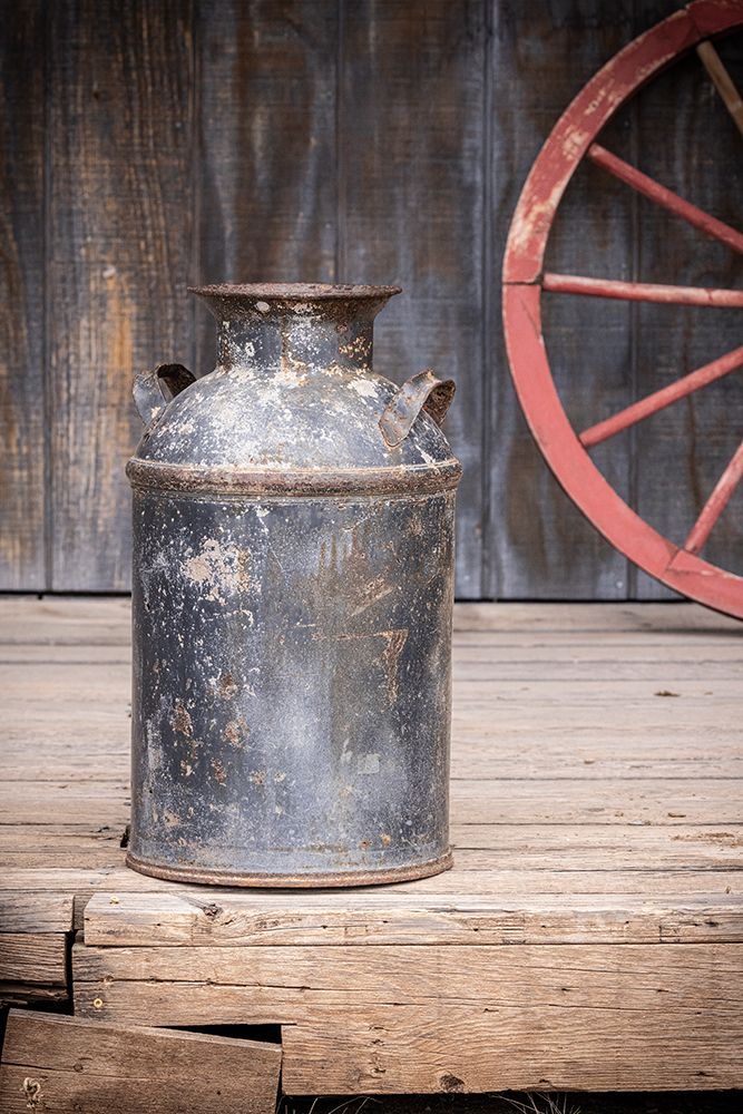 Still-life of old milk can and wagon wheel. art print by Emily M. Wilson for $57.95 CAD
