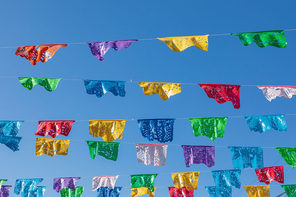 Todos Santos- Baja California Sur- Mexico. Festive colorful banners over a street. art print by Emily Wilson for $57.95 CAD