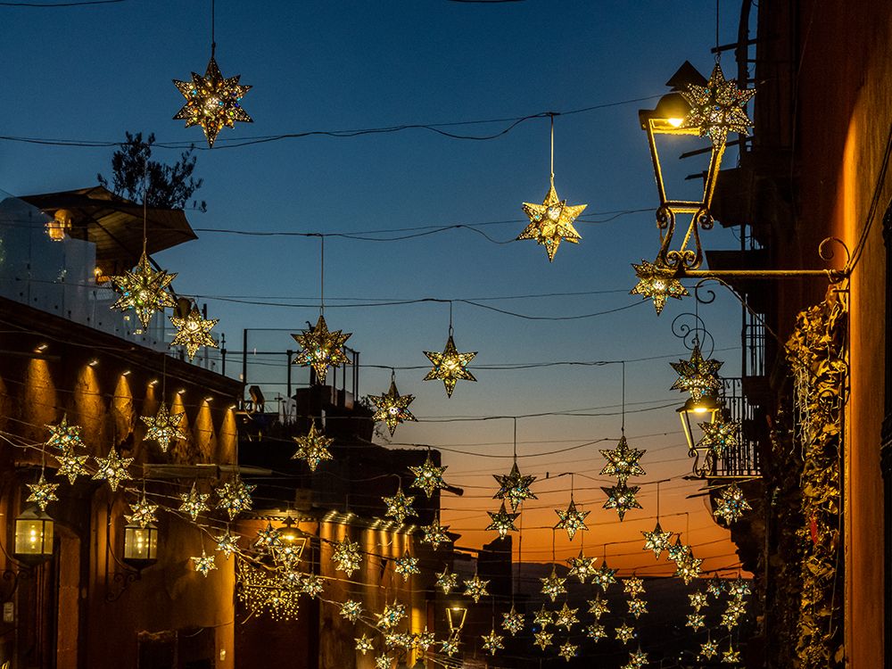 Mexico, San Miguel de Allende. Lighted stars suspended over a street at sunset. art print by Merrill Images for $57.95 CAD