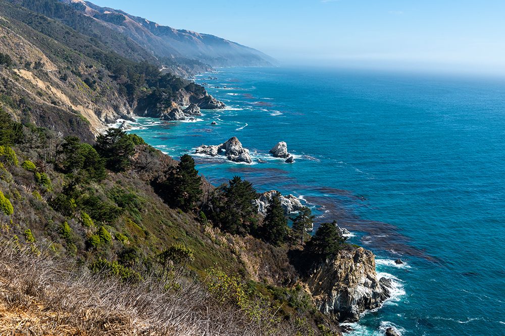 The rugged coastline of Big Sur-California with wisps of fog floating into the hills art print by Sheila Haddad for $57.95 CAD