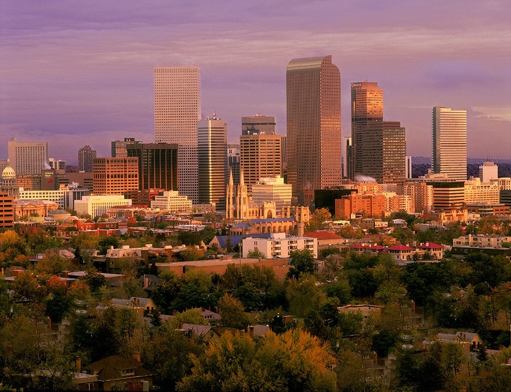 Denver-Colorado skyline glistens in early morning during sunrise against the Rocky Mountains art print by Steve Mohlenkamp for $57.95 CAD