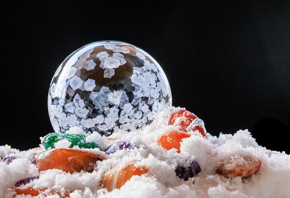 USA, Indiana, Carmel. Frozen soap bubble and polished stones in snow. art print by Jaynes Gallery for $57.95 CAD