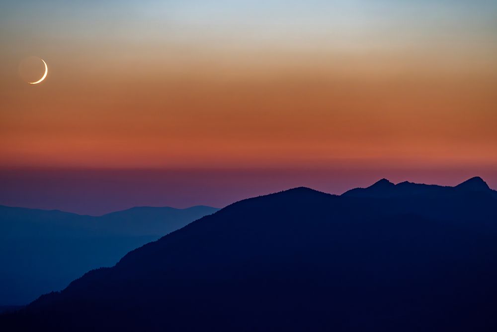 Crescent moon sets over the Whitefish Range in the Stillwater State Forest, Montana, USA art print by Chuck Haney for $57.95 CAD