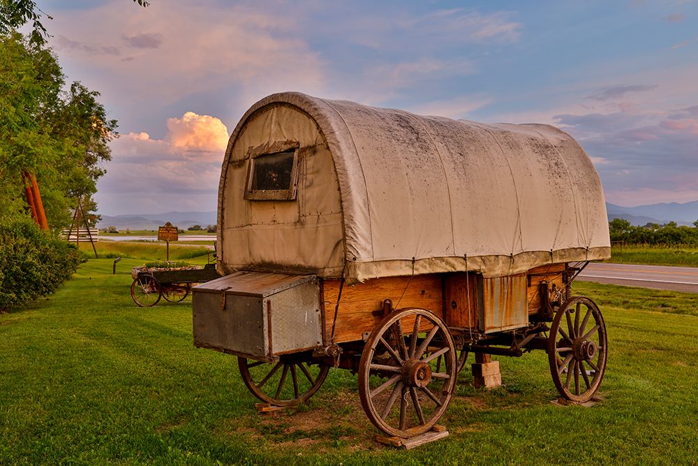 USA, Montana, Allentown. Evening light on covered wagon with evening sunset colors art print by Darrell Gulin for $57.95 CAD