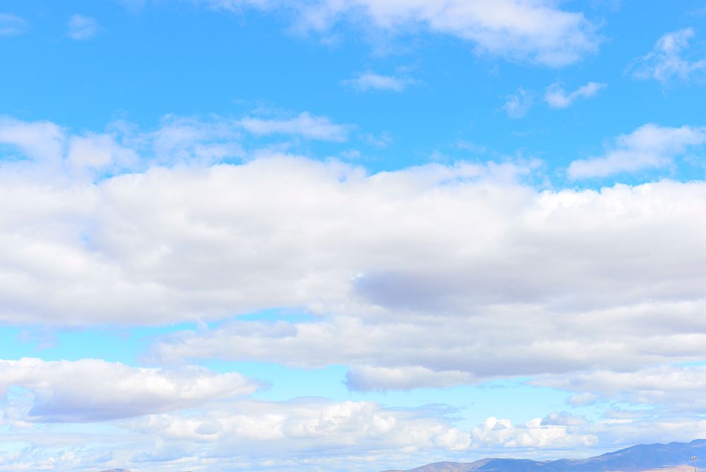 USA, Nevada, Wells, Cumulus Clouds in blue sky art print by Bernard Friel for $57.95 CAD