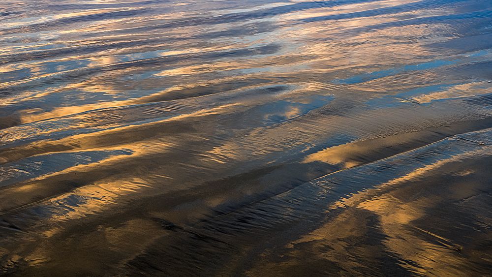 USA, New Jersey, Cape May National Seashore. Sunrise reflections on shore water and sand. art print by Jaynes Gallery for $57.95 CAD