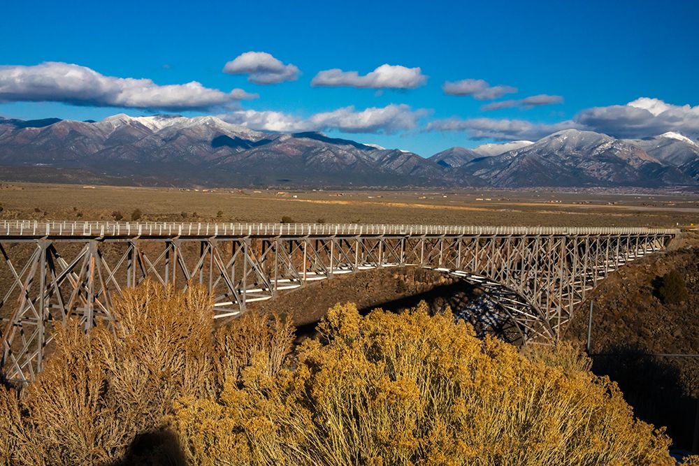 USA, New Mexico, Rio Grande del Norte NM. Rio Grande Gorge Bridge and snow-covered peaks. art print by Jaynes Gallery for $57.95 CAD