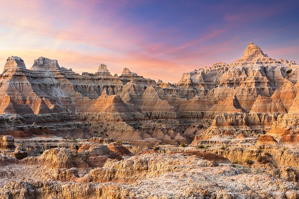 Magnificent set of striated hoodoos set against the backdrop of sunset colors in the sky art print by Sheila Haddad for $57.95 CAD