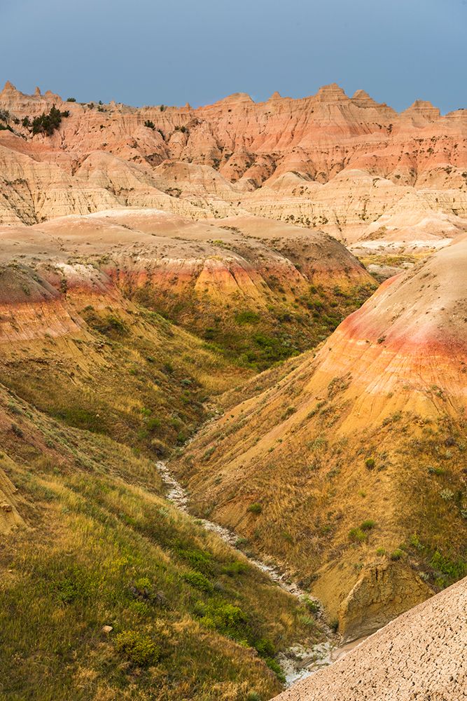 The grassy valley with dry creek is fed by the run off of the hoodoos lining the side art print by Sheila Haddad for $57.95 CAD