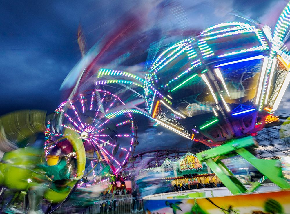 Motion blur of rides at Washington State Fair at Puyallup. art print by Merrill Images for $57.95 CAD