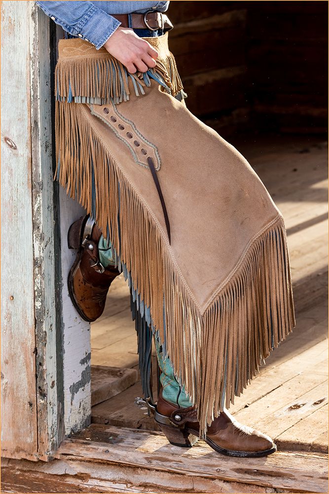 USA- Shell- Wyoming. Hideout Ranch cowgirl standing in doorway with cowboy boots and chaps. art print by Darrell Gulin for $57.95 CAD