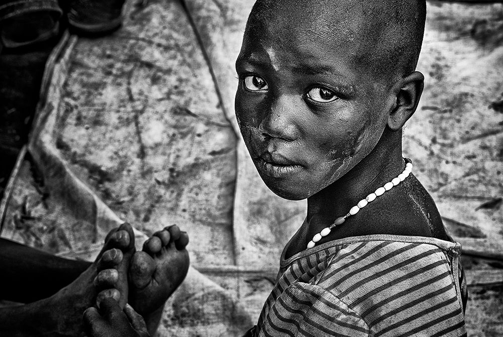 Larim Tribe Girl Massaging Feet - South Sudan art print by Joxe Inazio Kuesta for $57.95 CAD