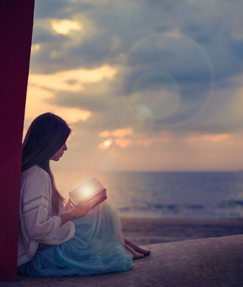 Woman Sitting On A Beach With Illuminated Book art print by Alla Simacheva for $57.95 CAD