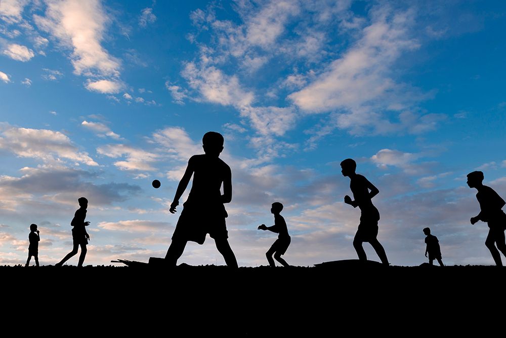 Boys Playing At Sunset art print by Kuntal Biswas for $57.95 CAD