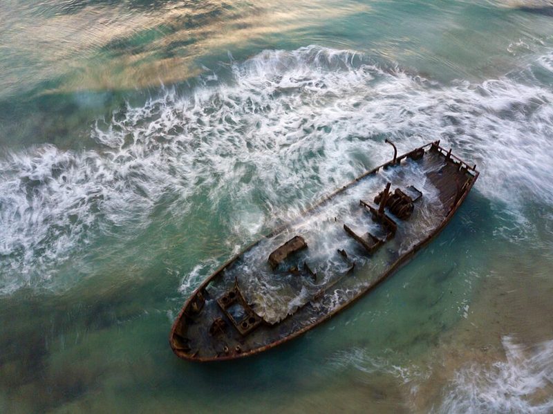 Ocean Waves Shipwreck art print by eMunther for $57.95 CAD