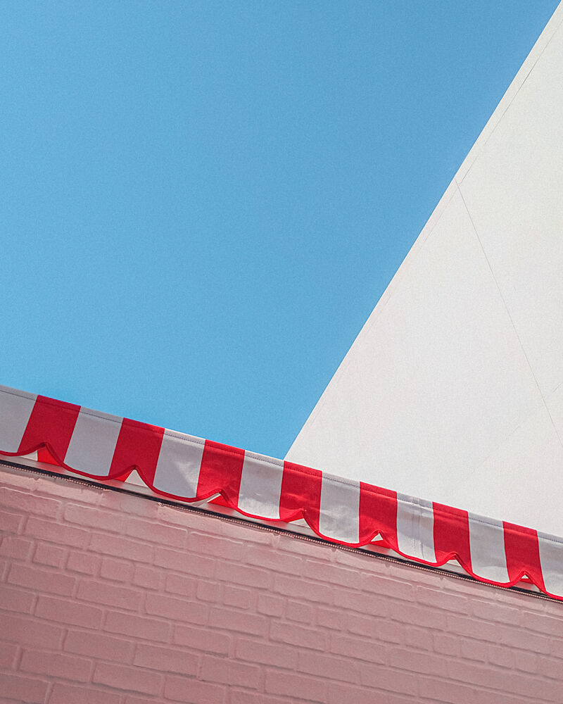 Red Awning Blue Sky art print by Tom Windeknecht for $57.95 CAD
