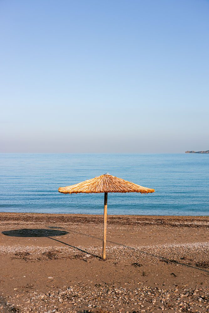 Straw Umbrella Beach View art print by HelloHappylife for $57.95 CAD