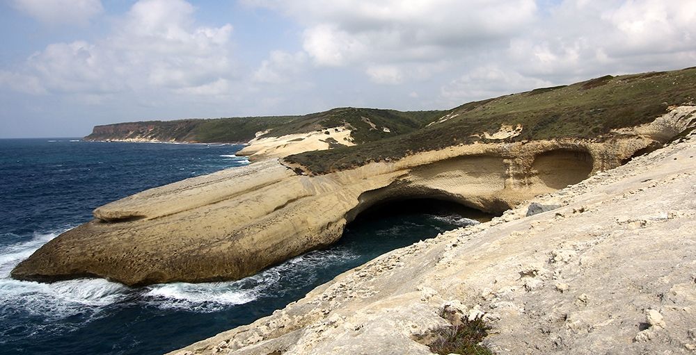 Flat rocks with natural arch on the coast of Sardinia Island art print by Giovanni Saiu for $57.95 CAD