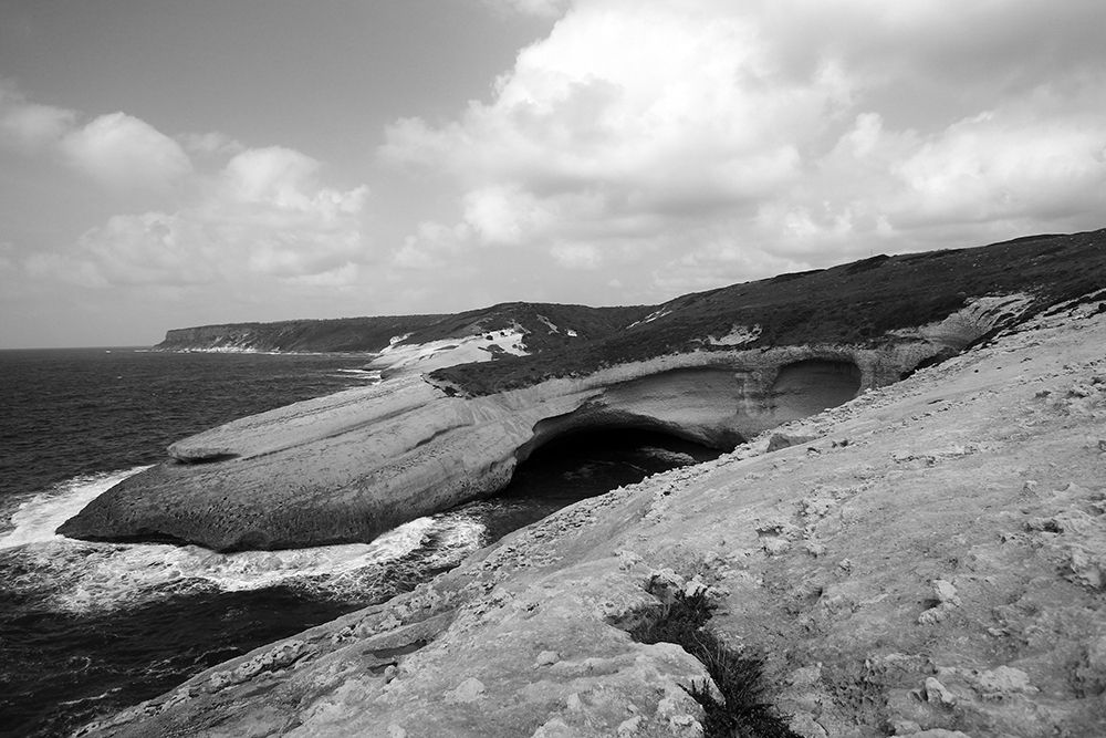 Flat rocks with natural arch on the coast of Sardinia Island ? black and white art print by Giovanni Saiu for $57.95 CAD