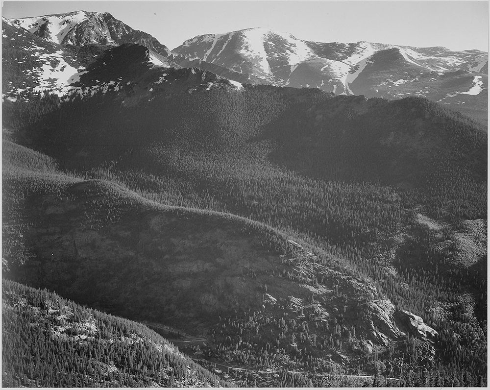 View of wooded hills with mountains in background, in Rocky Mountain National Park, Colorado, ca. 19 art print by Ansel Adams for $57.95 CAD