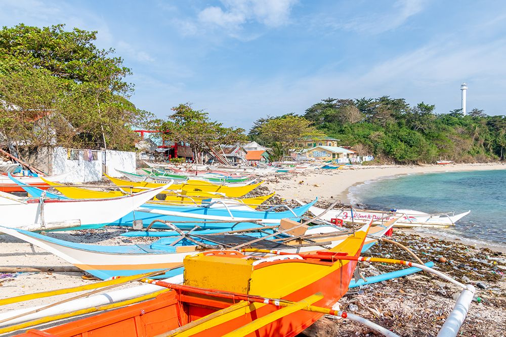 Colorful Fishing Boats with Distant Lighthouse, Philippines art print by Richard Silver for $57.95 CAD