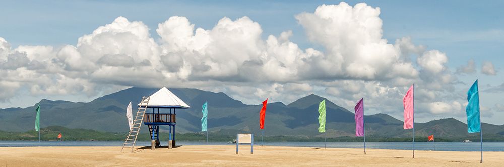 Beach Hut with Colorful Flags and Mountain View, Philippines art print by Richard Silver for $57.95 CAD