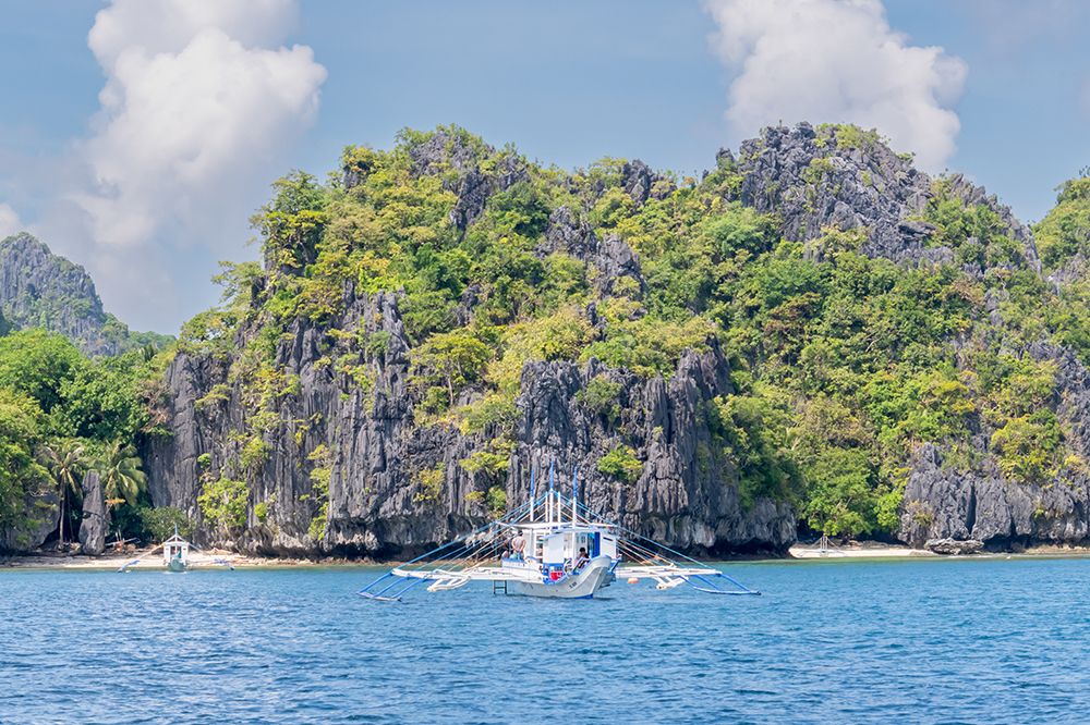 Bangka Boat Passing Limestone Cliffs, El Nido, Palawan, Philippines art print by Richard Silver for $57.95 CAD