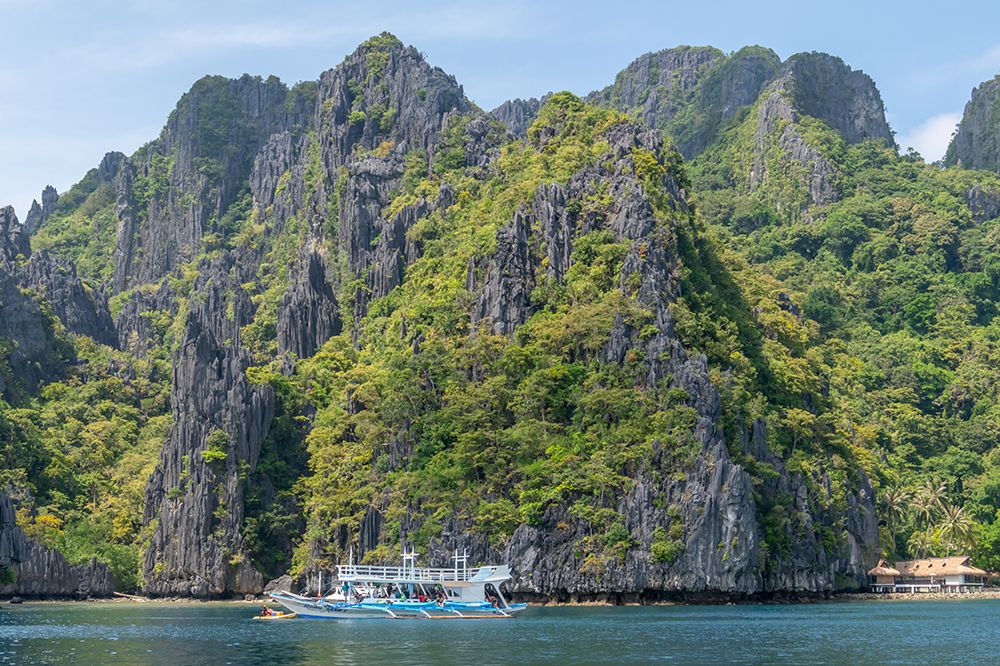 Boat Beneath Towering Karst Cliffs, El Nido, Palawan, Philippines art print by Richard Silver for $57.95 CAD