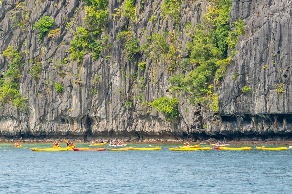 Kayakers Along Limestone Cliffs, El Nido, Palawan, Philippines art print by Richard Silver for $57.95 CAD