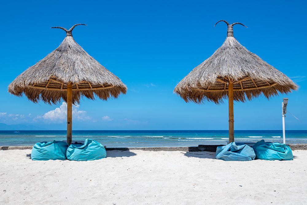 Thatched Beach Umbrellas with Teal Loungers, Gili Islands, Indonesia art print by Richard Silver for $57.95 CAD