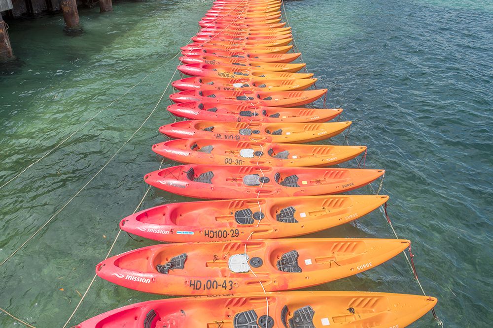 Rows of Orange Kayaks on Turquoise Water art print by Richard Silver for $57.95 CAD