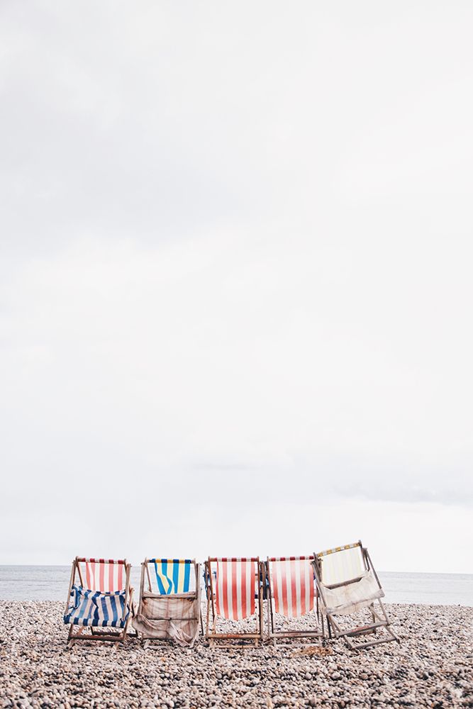 Colored striped beach chairs art print by Artographie for $57.95 CAD